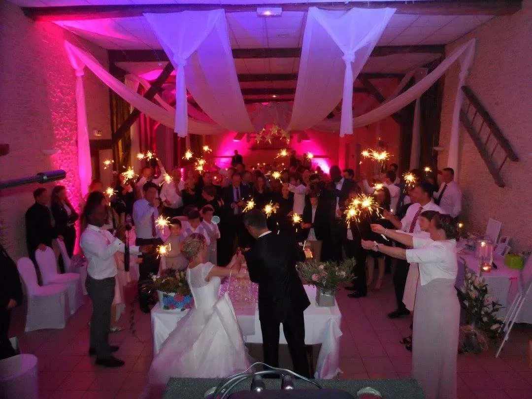 Des invités qui dansent sous les lumières en fin de soirée